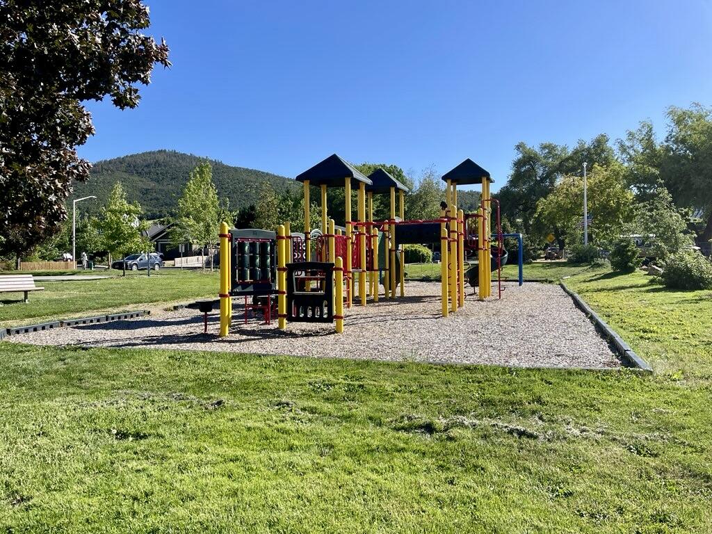 1227 Lithia Way Talent, OR 97540 - Photo 33 of 37 a view of a park with swings and slides