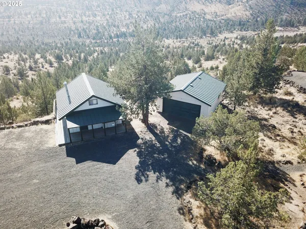 an aerial view of a house with a yard