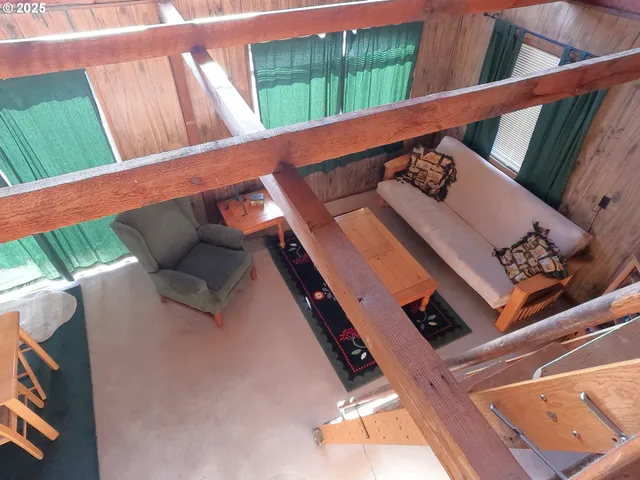 a view of deck with furniture and a black door