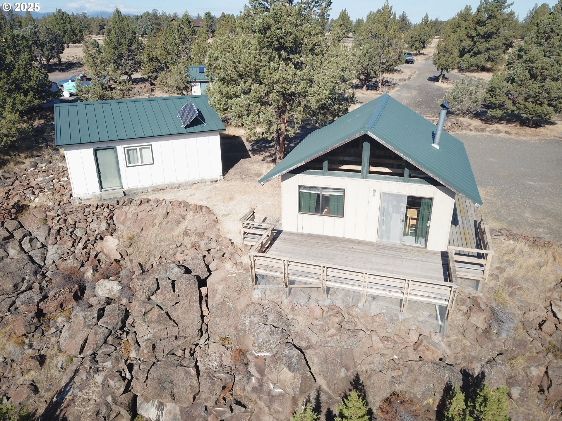 11195 Southwest Yucca Flats Lane Culver, OR 97734 - Photo 6 of 25 a front view of a house with a yard and garage