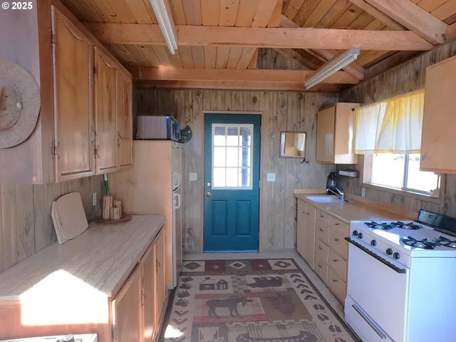 a kitchen with stainless steel appliances granite countertop a sink stove and cabinets