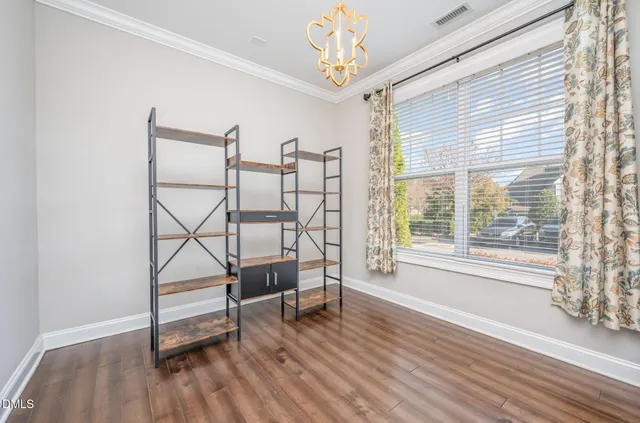 a view of a room with wooden floor and windows