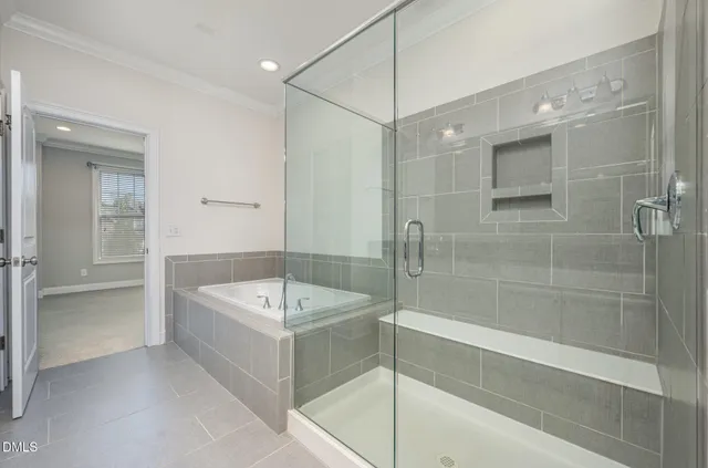a bathroom with a tub a sink shower and mirror
