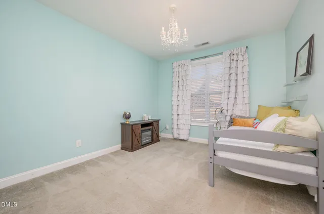 a bedroom with furniture and a chandelier