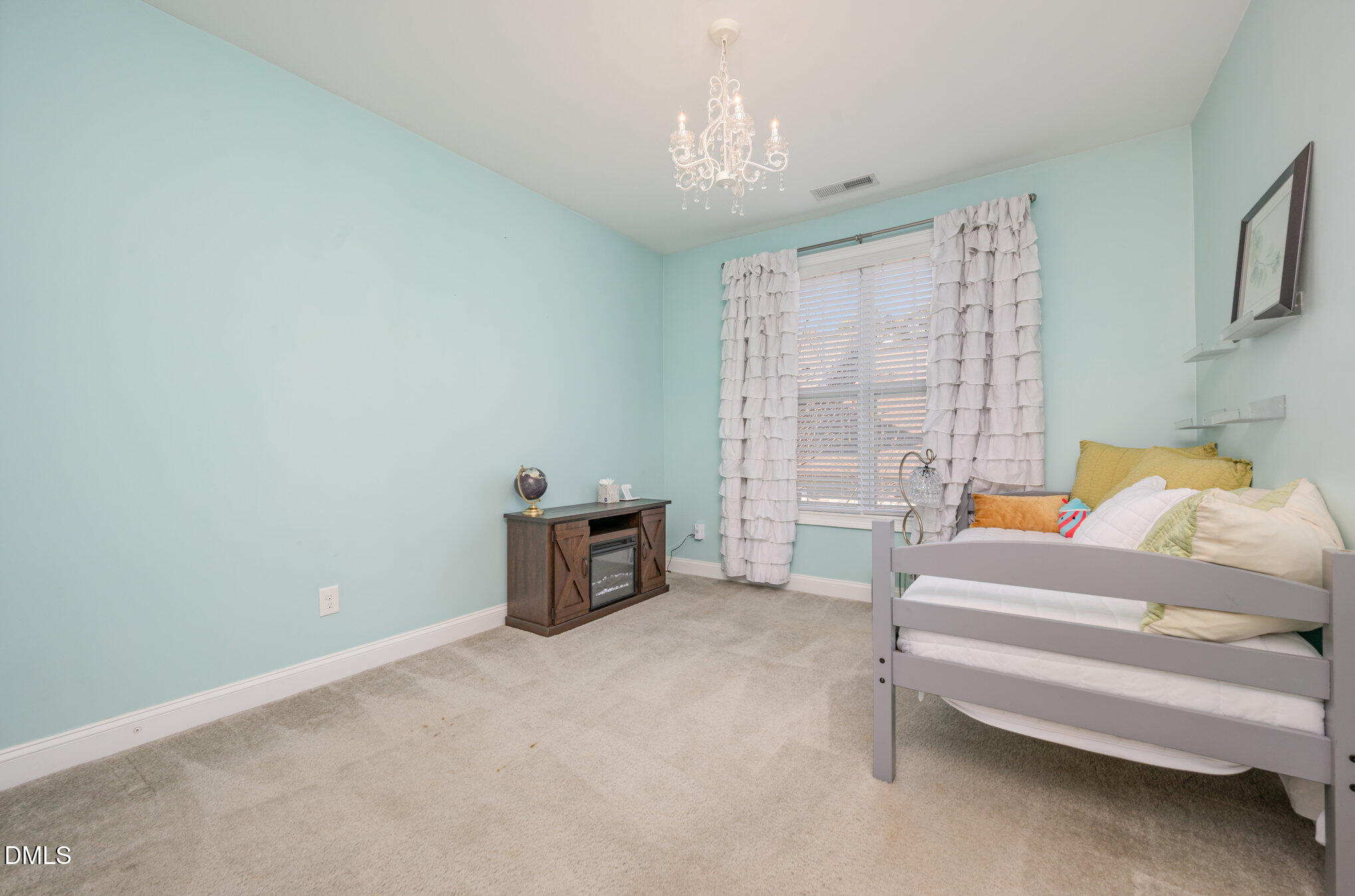 708 Fallon Grove Way Raleigh, NC 27608 - Photo 17 of 27 a bedroom with furniture and a chandelier