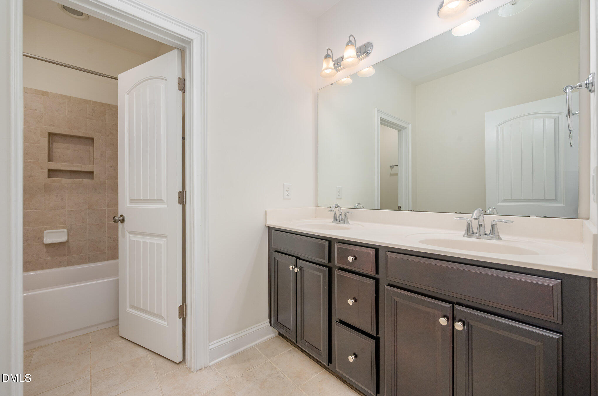 708 Fallon Grove Way Raleigh, NC 27608 - Photo 19 of 27 a bathroom with a double vanity sink a tub and a mirror