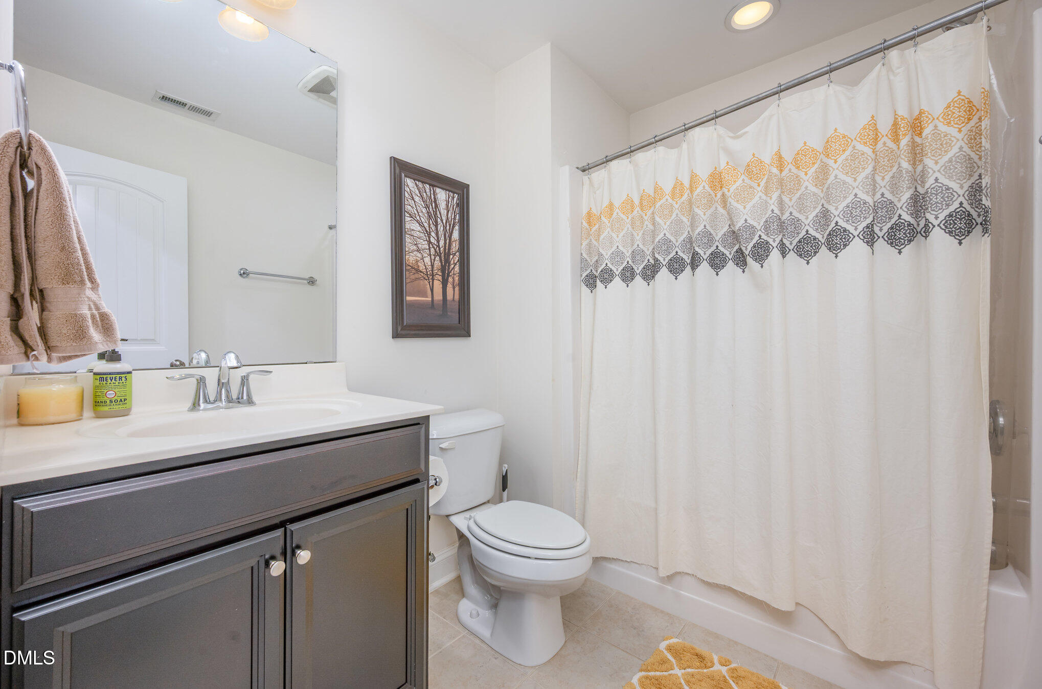 708 Fallon Grove Way Raleigh, NC 27608 - Photo 22 of 27 a bathroom with a granite countertop sink a toilet and a mirror