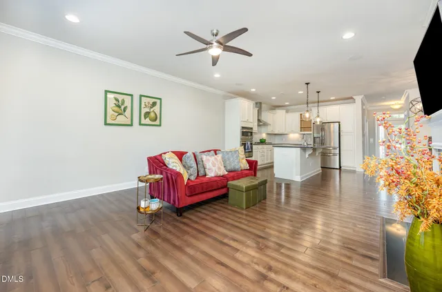 a living room with furniture and kitchen view