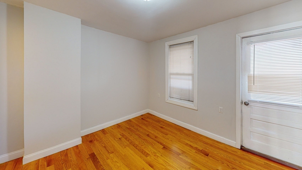 67 Marion Street, Unit 3 Boston, MA 02128 - Photo 11 of 16 a view of empty room with wooden floor