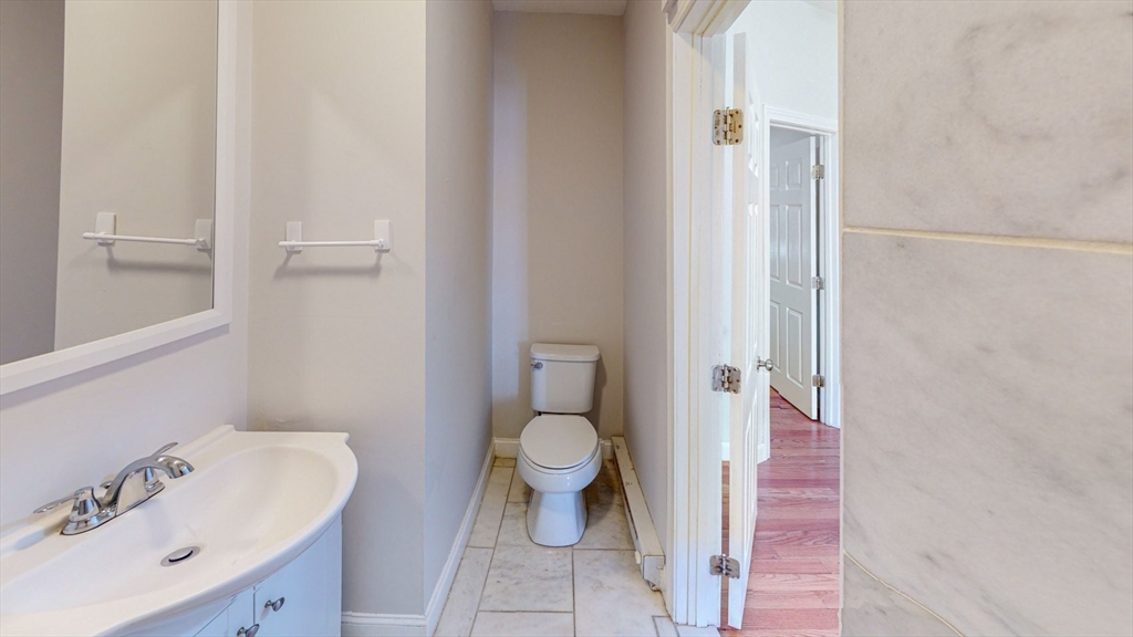67 Marion Street, Unit 3 Boston, MA 02128 - Photo 9 of 16 a bathroom with a sink and toilet