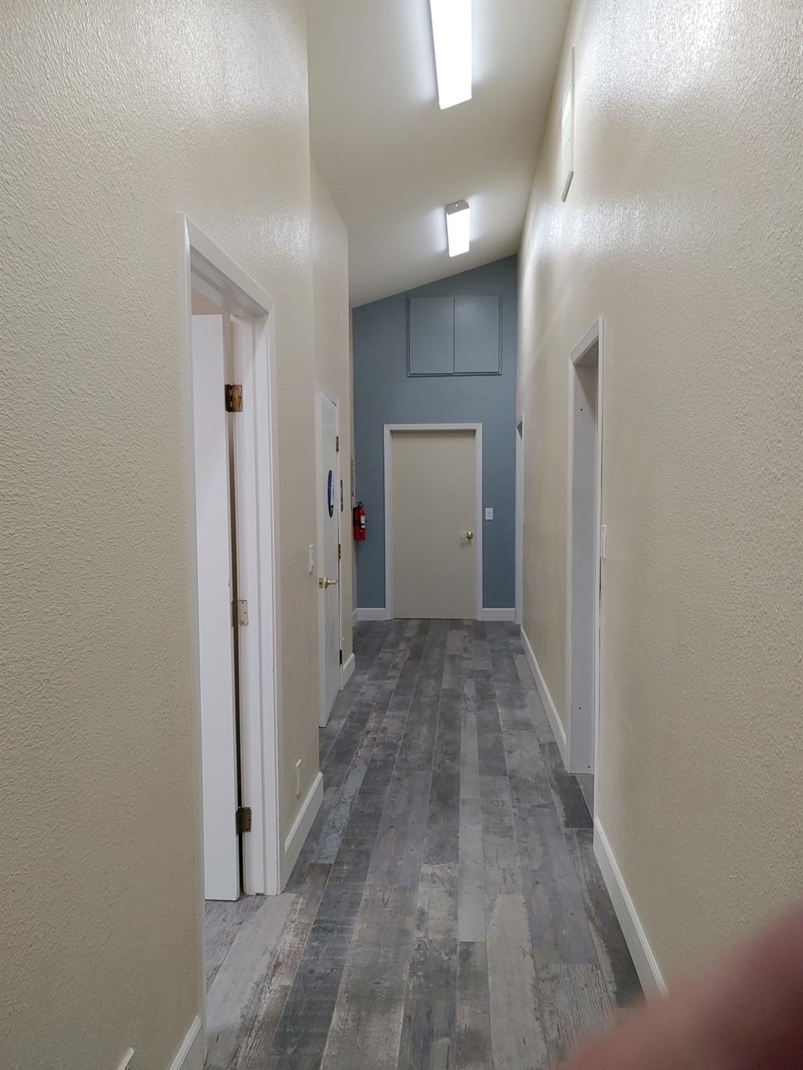 1333 Highway 174 Colfax, CA 95713 - Photo 33 of 88 corridor with a textured wall, vaulted ceiling, and vinyl plank style flooring