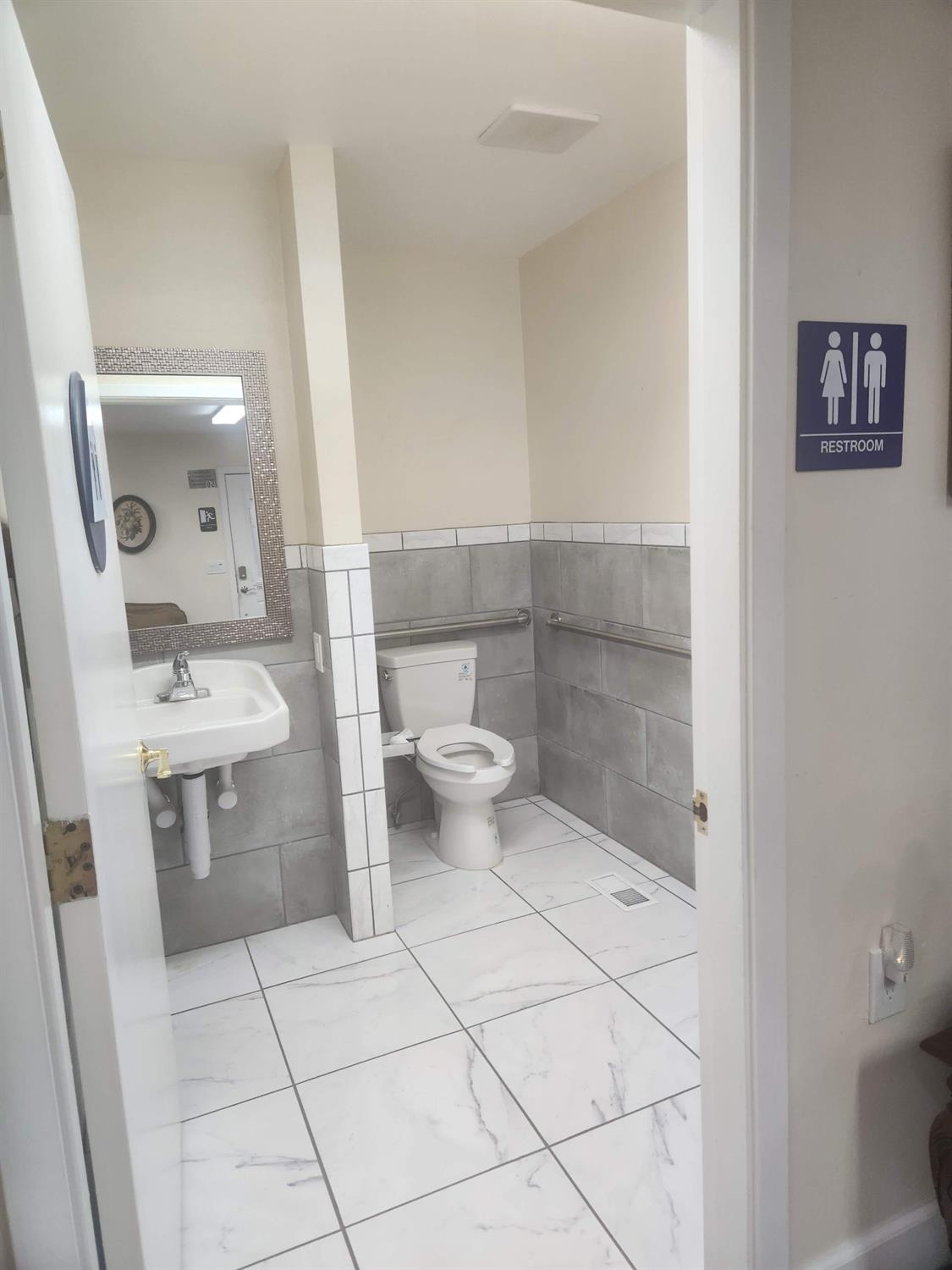 1333 Highway 174 Colfax, CA 95713 - Photo 80 of 88 bathroom featuring tile walls, wainscoting, and light marble finish floors