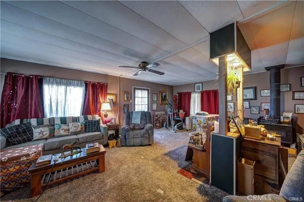 a living room with furniture fireplace and window