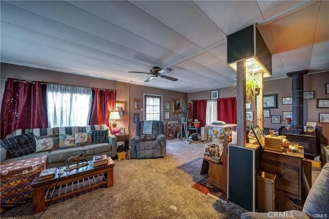 a living room with furniture fireplace and window