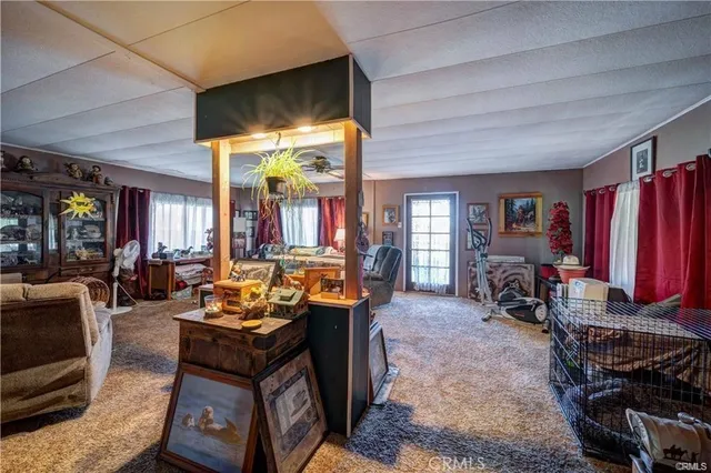 a living room with furniture a flat screen tv and large window