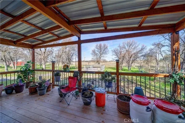 a living room with patio furniture and a potted plant