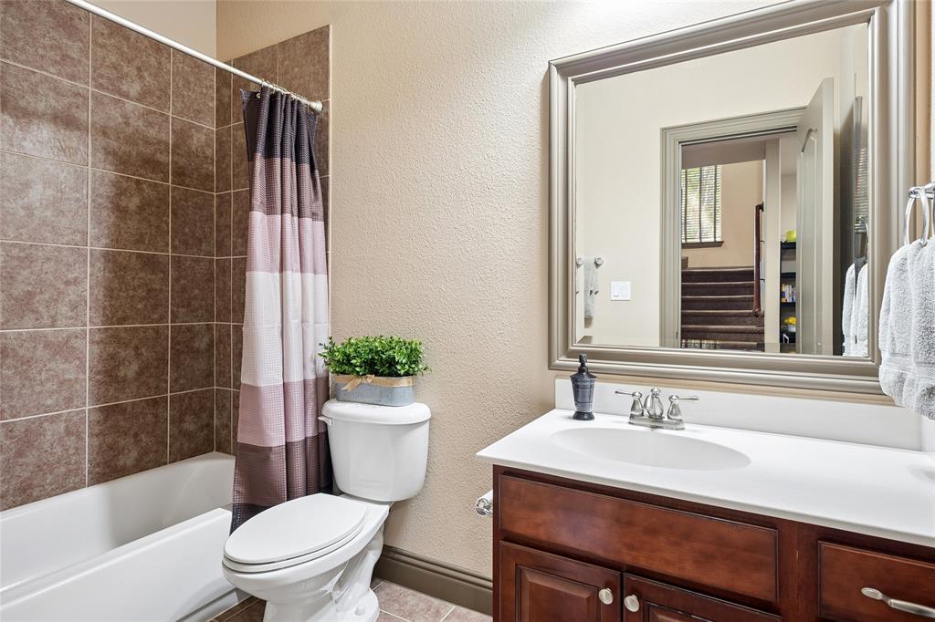 835 Rockingham Drive Irving, TX 75063 - Photo 21 of 27 a bathroom with a sink toilet and shower