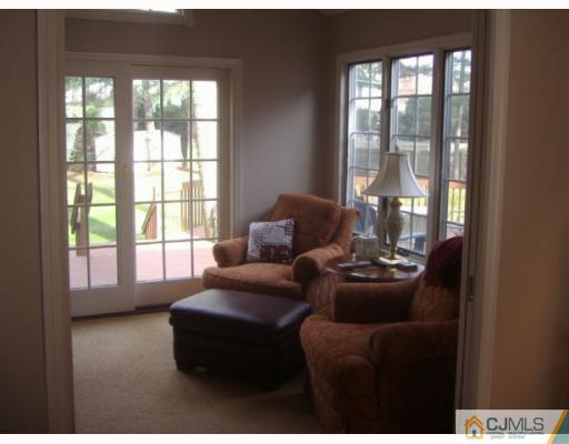 33 Clive Hills Road Edison, NJ 08820 - Photo 5 of 10 a living room with furniture and floor to ceiling windows