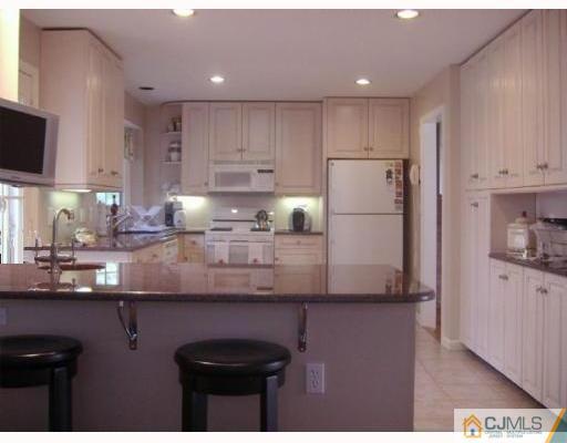 33 Clive Hills Road Edison, NJ 08820 - Photo 10 of 10 a kitchen with kitchen island a sink a center island stainless steel appliances and cabinets