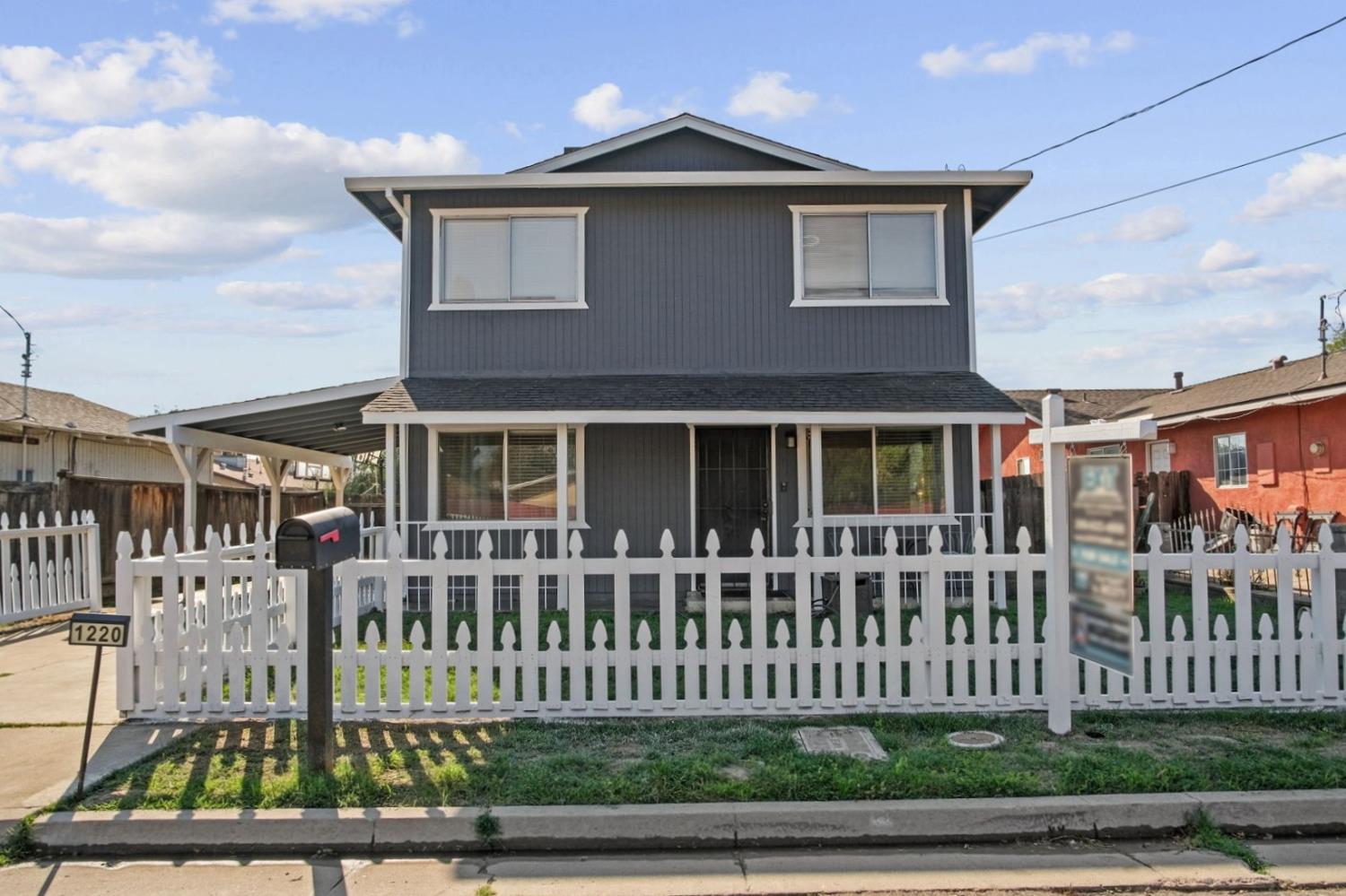 1220 Fig Avenue Merced, CA 95341 - Photo 1 of 17 a front view of a house with a garden