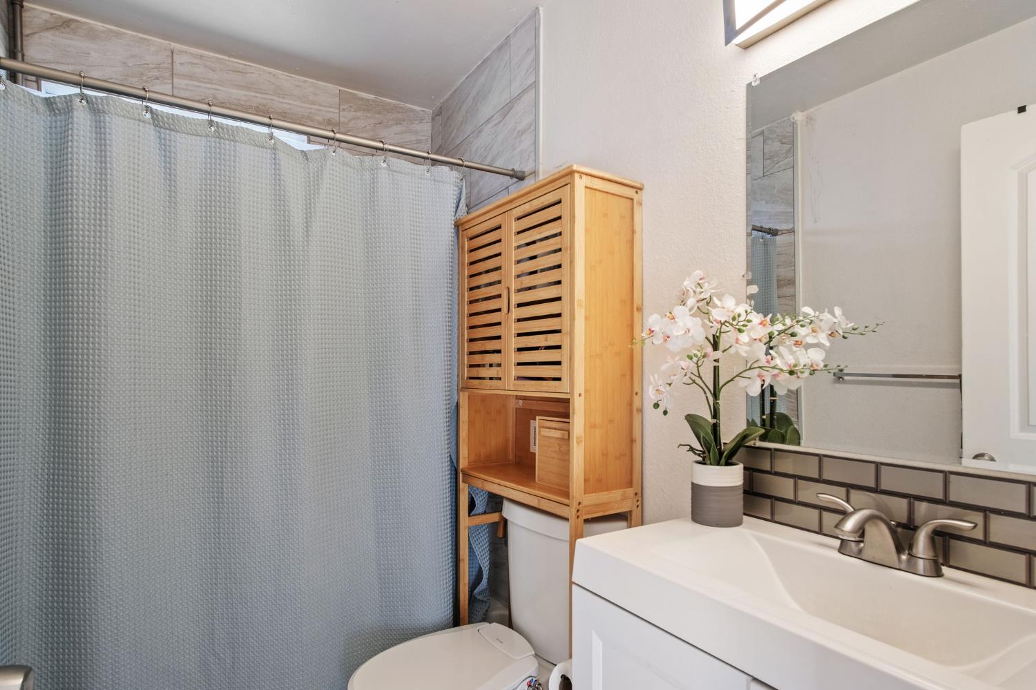 1220 Fig Avenue Merced, CA 95341 - Photo 12 of 17 a bathroom with a sink and mirror with toilet