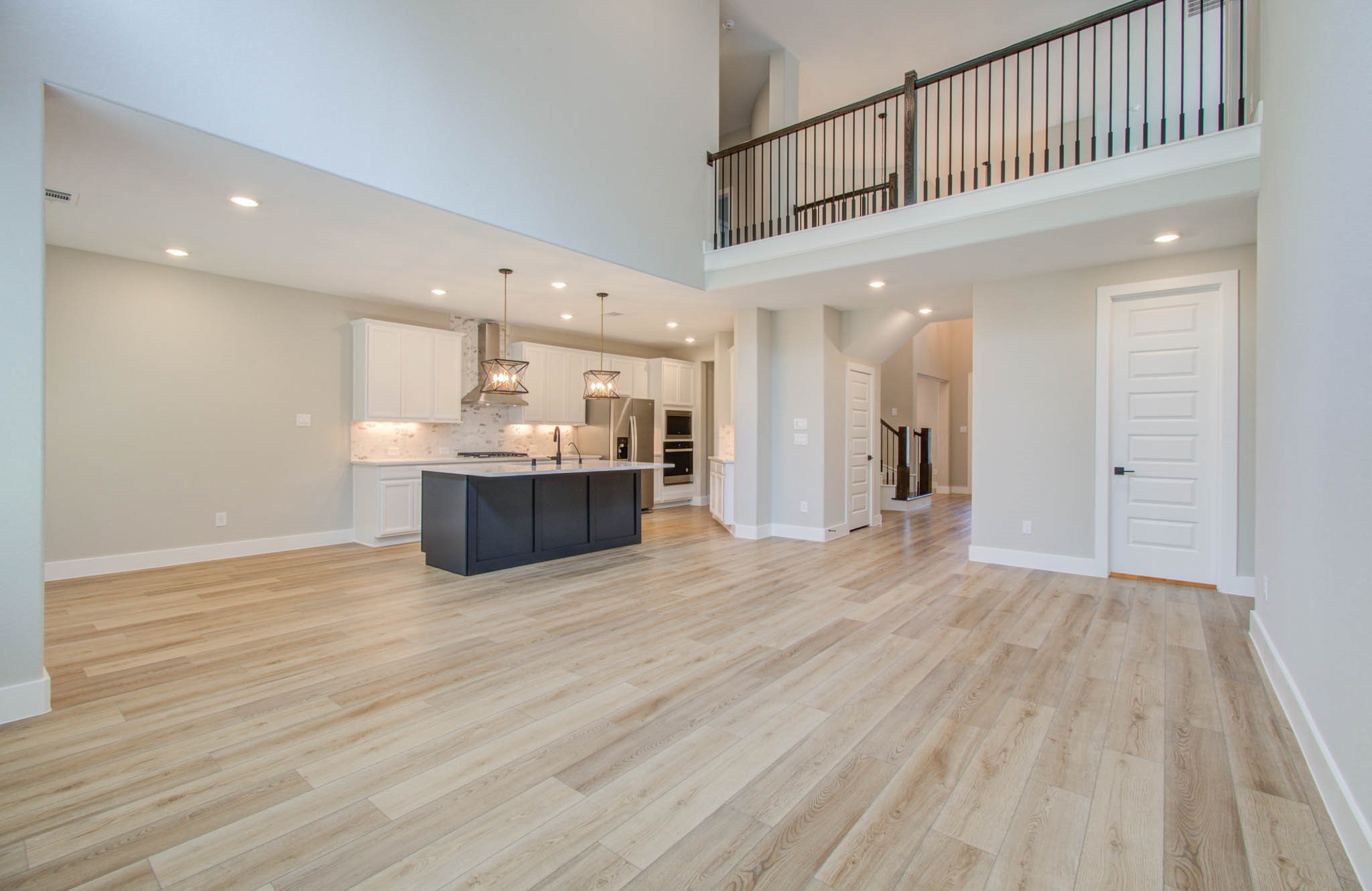 9950 Wild Indigo Circle Conroe, TX 77385 - Photo 12 of 50 a view of a hallway with wooden floor and kitchen