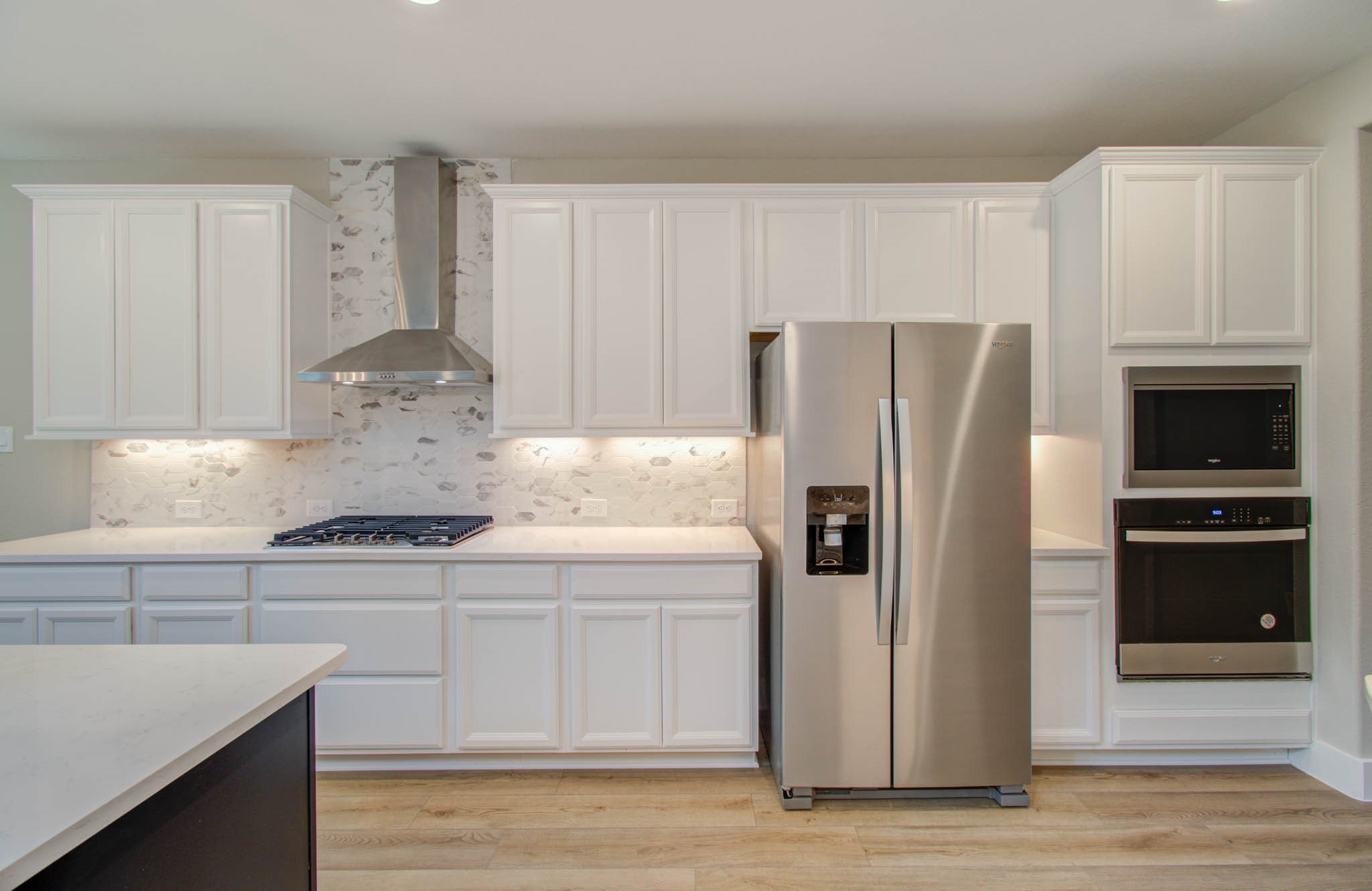 9950 Wild Indigo Circle Conroe, TX 77385 - Photo 17 of 50 a kitchen with granite countertop a refrigerator and a stove