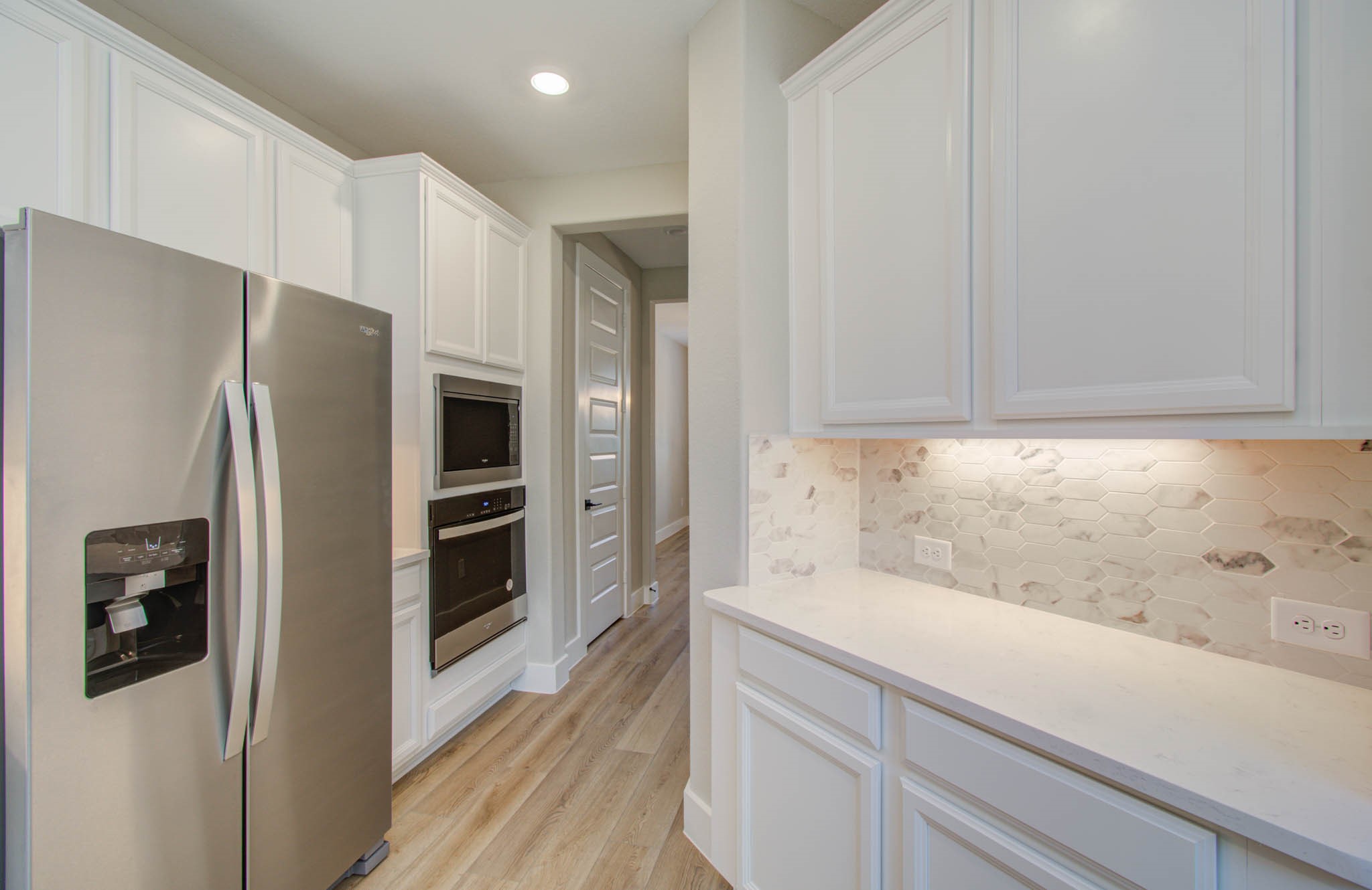 9950 Wild Indigo Circle Conroe, TX 77385 - Photo 18 of 50 a kitchen with a refrigerator and a sink