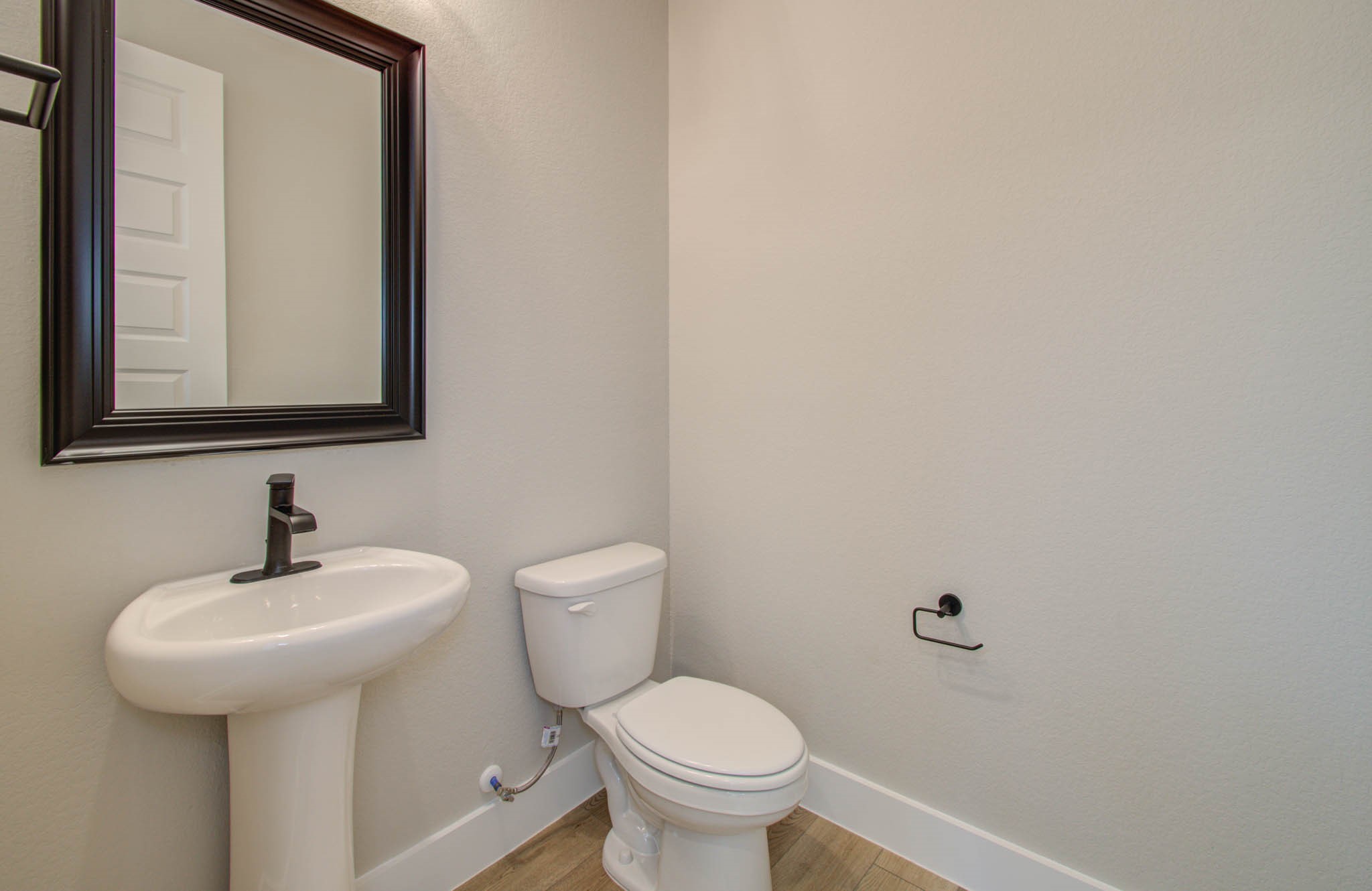 9950 Wild Indigo Circle Conroe, TX 77385 - Photo 19 of 50 a bathroom with a toilet sink and mirror