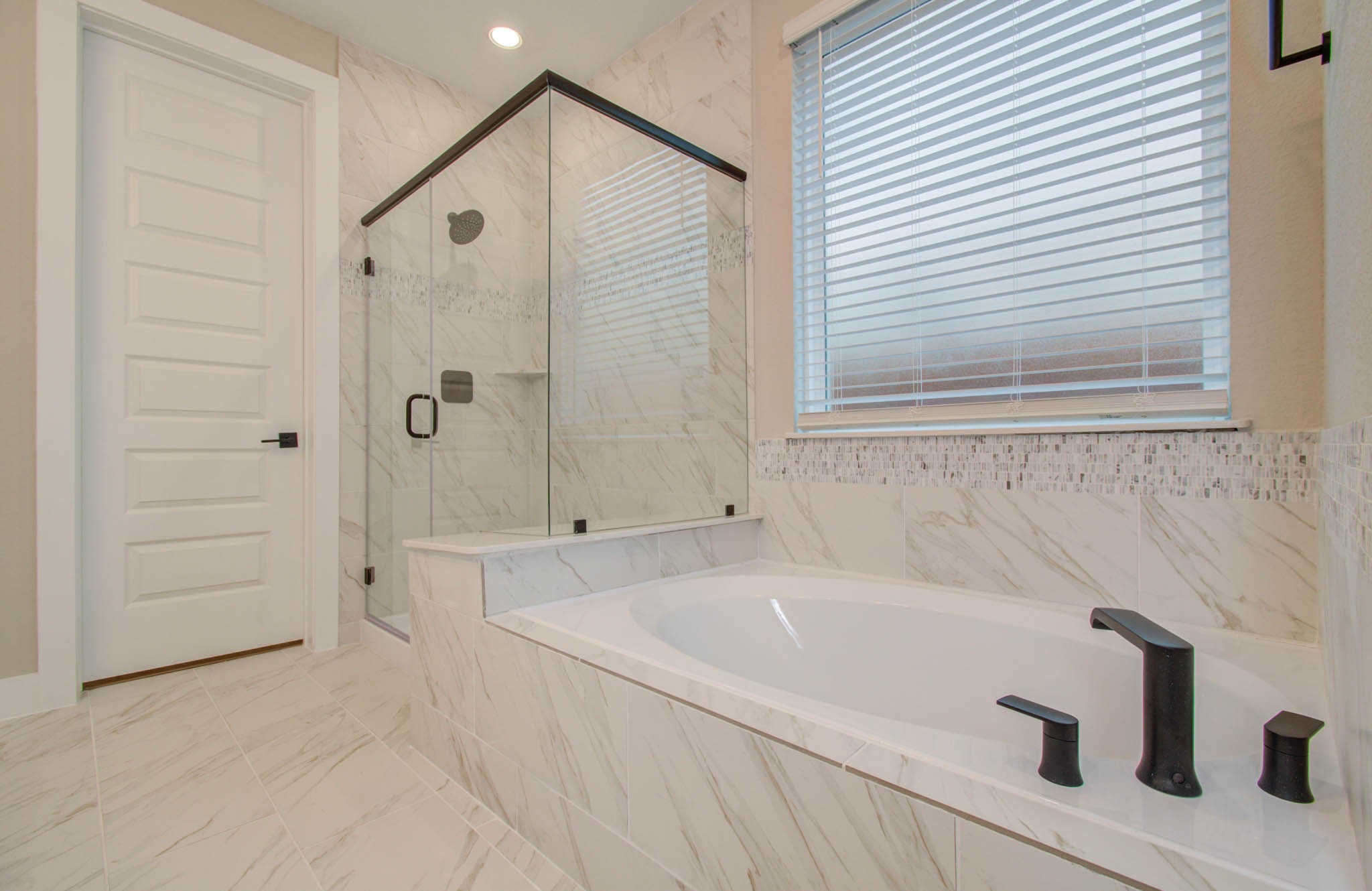 9950 Wild Indigo Circle Conroe, TX 77385 - Photo 24 of 50 a bathroom with a tub and a shower