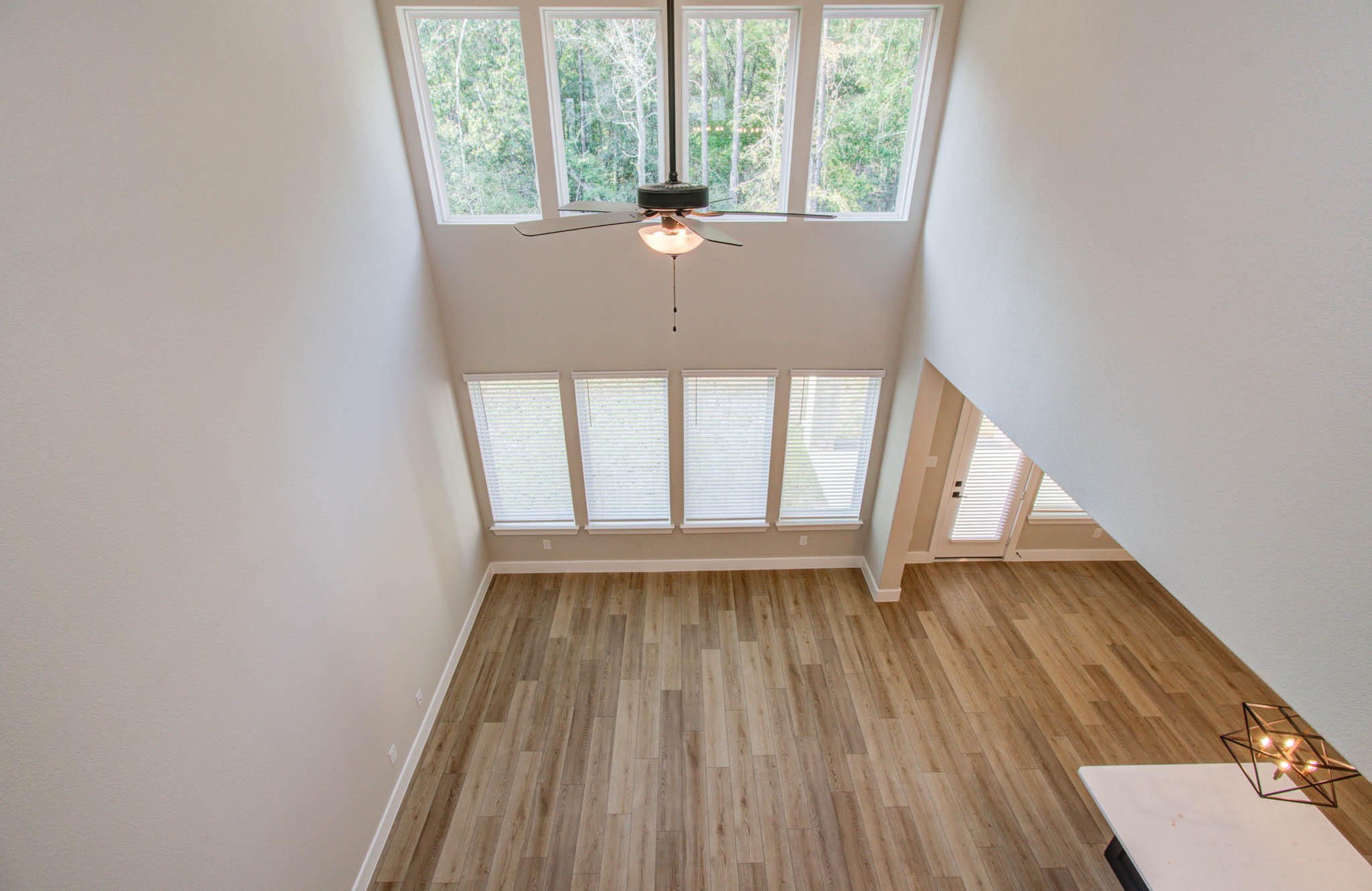 9950 Wild Indigo Circle Conroe, TX 77385 - Photo 28 of 50 a view of an empty room with wooden floor and a window