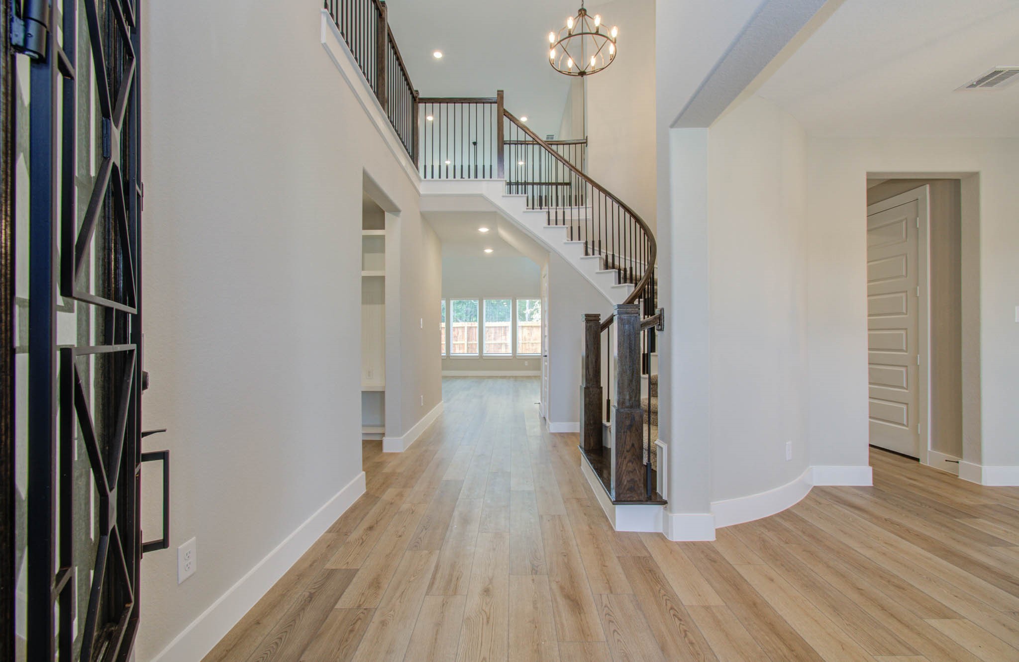 9950 Wild Indigo Circle Conroe, TX 77385 - Photo 3 of 50 a view of entryway and hall with wooden floor