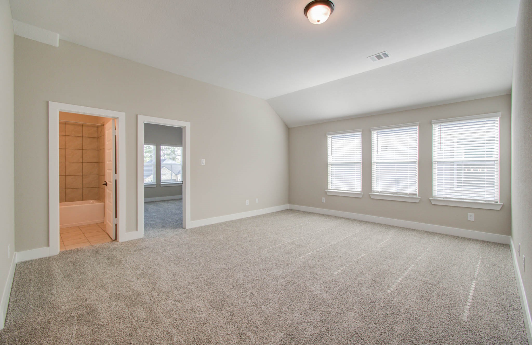 9950 Wild Indigo Circle Conroe, TX 77385 - Photo 31 of 50 a view of an empty room with glass door and windows