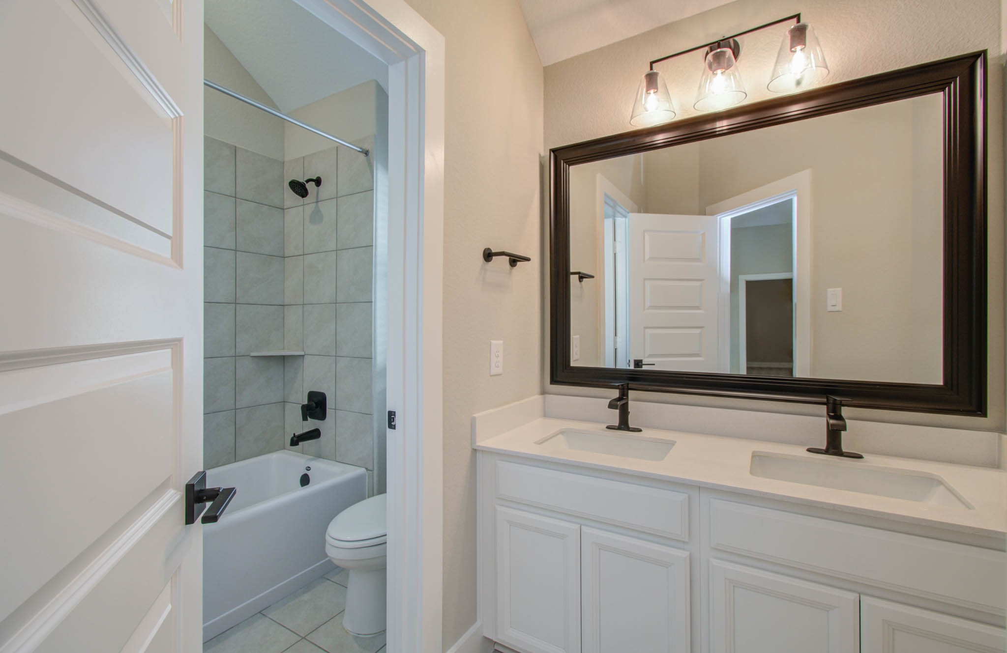 9950 Wild Indigo Circle Conroe, TX 77385 - Photo 37 of 50 a bathroom with a sink a toilet and shower