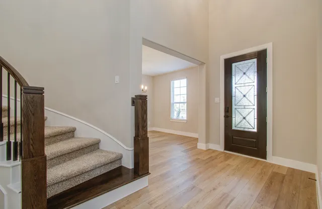 a view of a room with wooden floor exposed radiator and windows