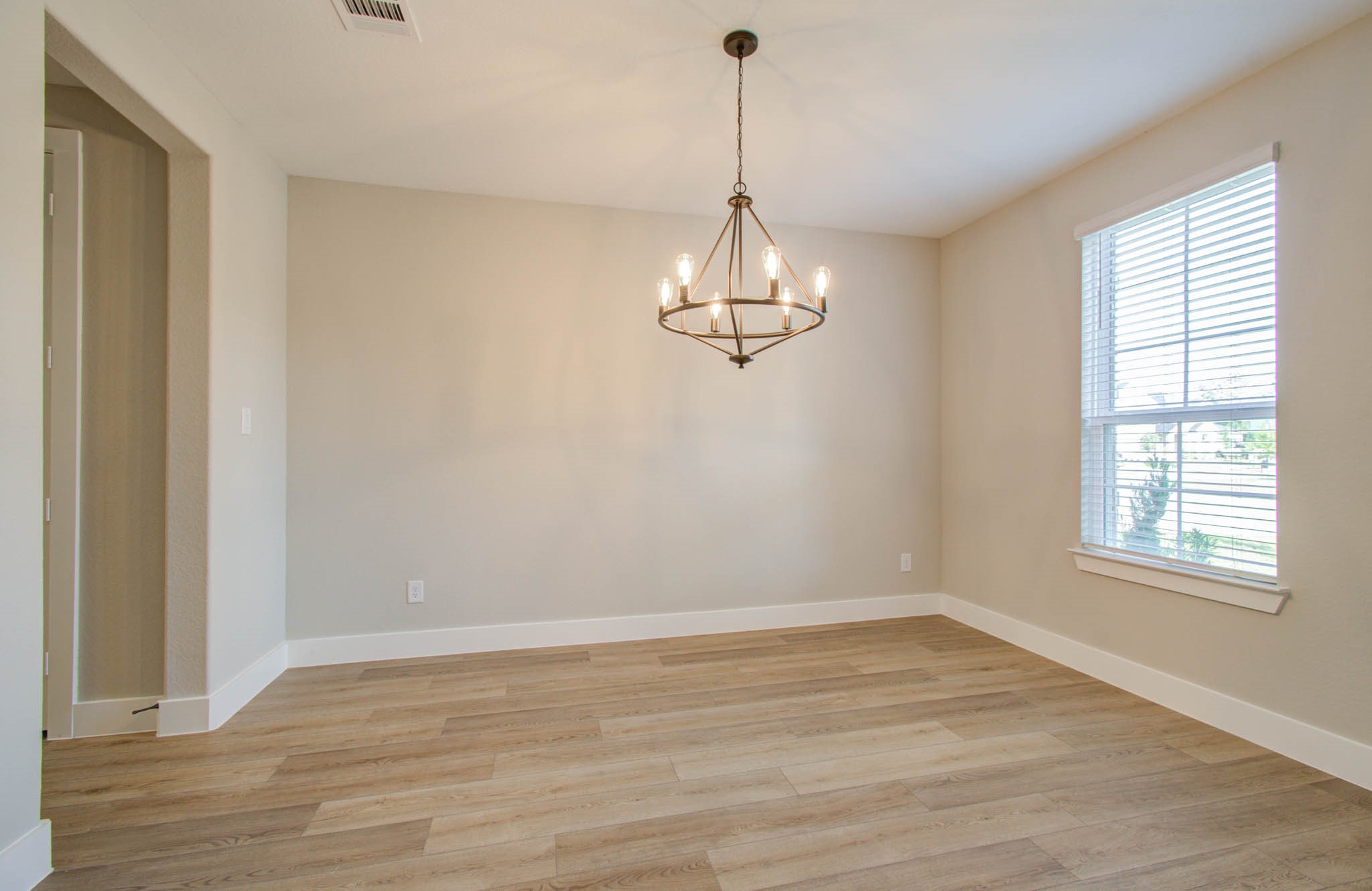 9950 Wild Indigo Circle Conroe, TX 77385 - Photo 5 of 50 a view of a room with wooden floor exposed radiator and windows