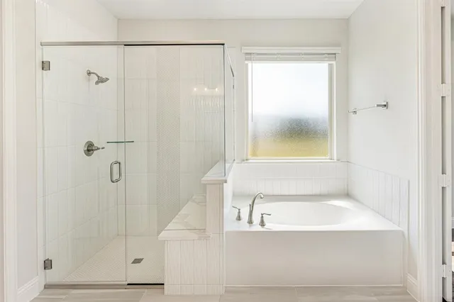 a bathroom with a bathtub and shower