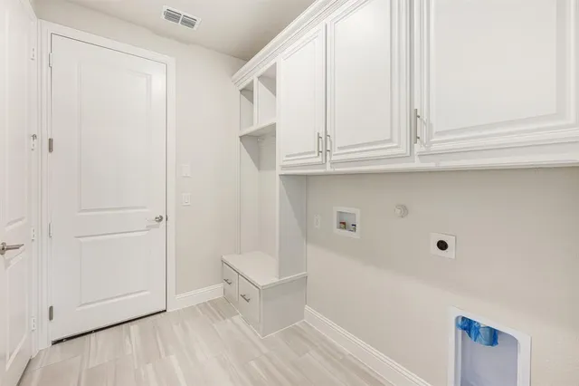 a view of room with cabinet and entryway