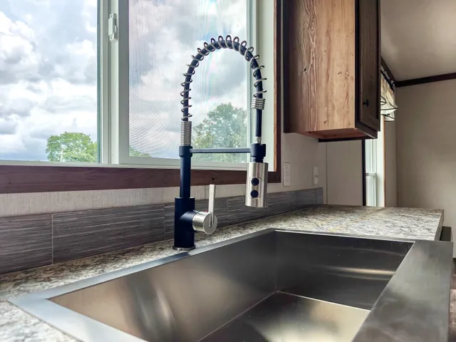 a kitchen with a sink and a mirror