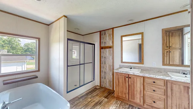 a bathroom with a double vanity sink a mirror and a bathtub