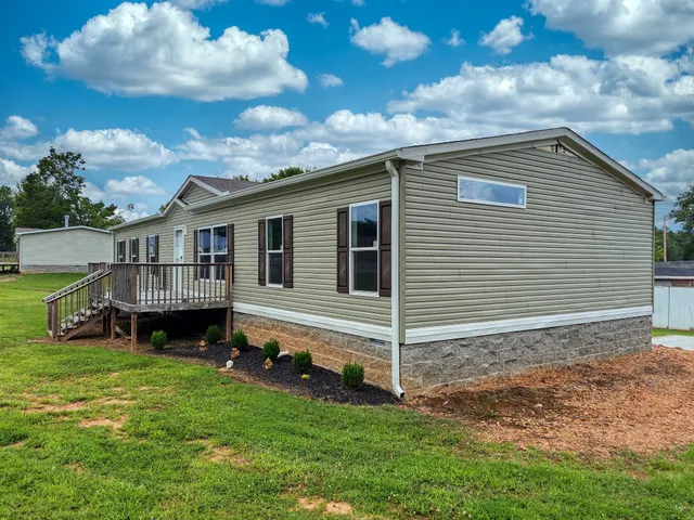 a view of backyard with a garden and deck