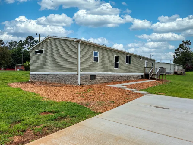 a backyard of a house with lots of green space and outdoor space