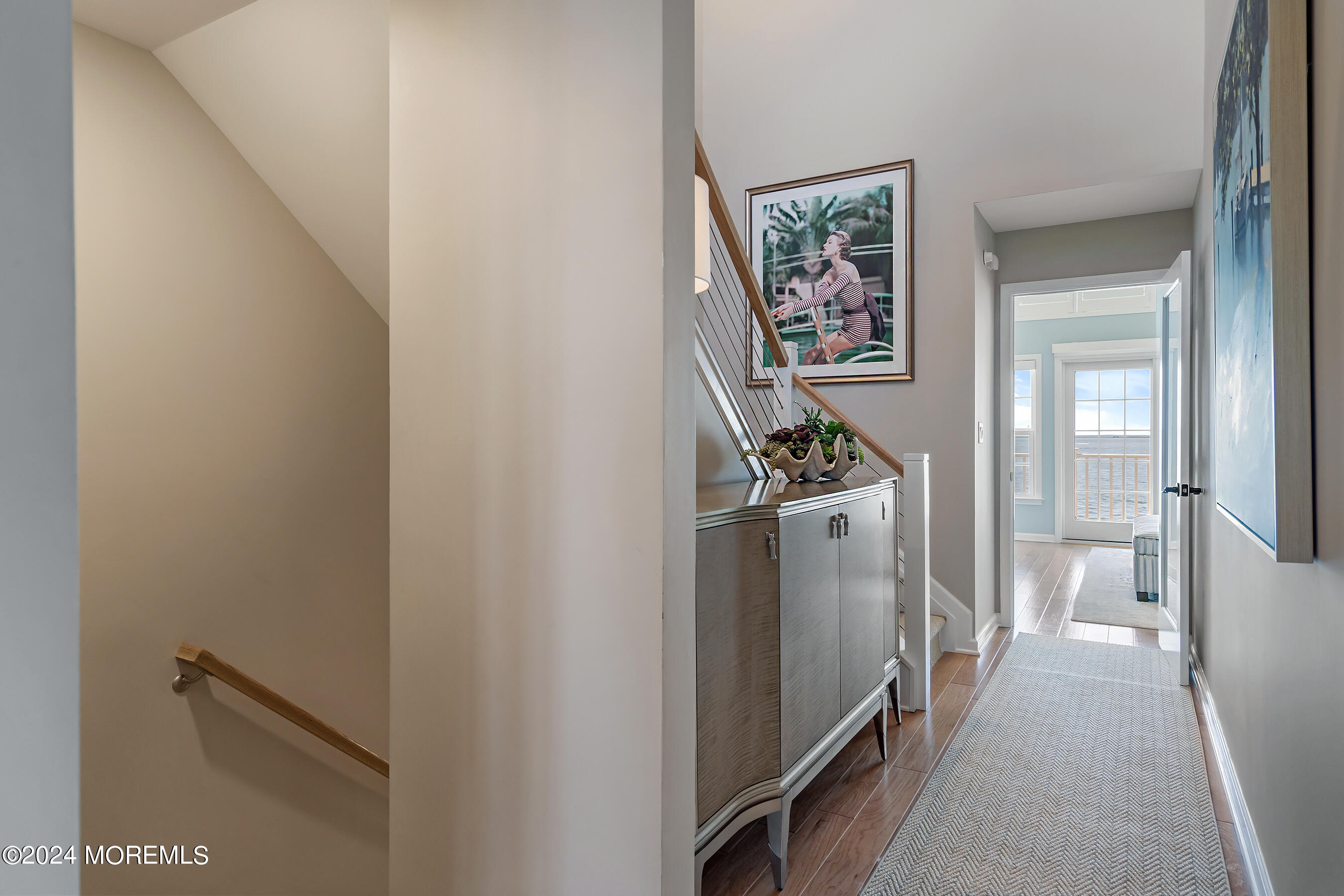 8 Lighthouse Point Road, Unit 703 Highlands, NJ 07732 - Photo 24 of 43 a hallway with painting and a stairs
