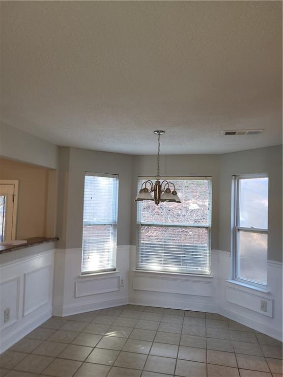 4234 Winston Circle Atlanta, GA 30349 - Photo 6 of 19 a room with granite countertop natural light wood cabinets and a window