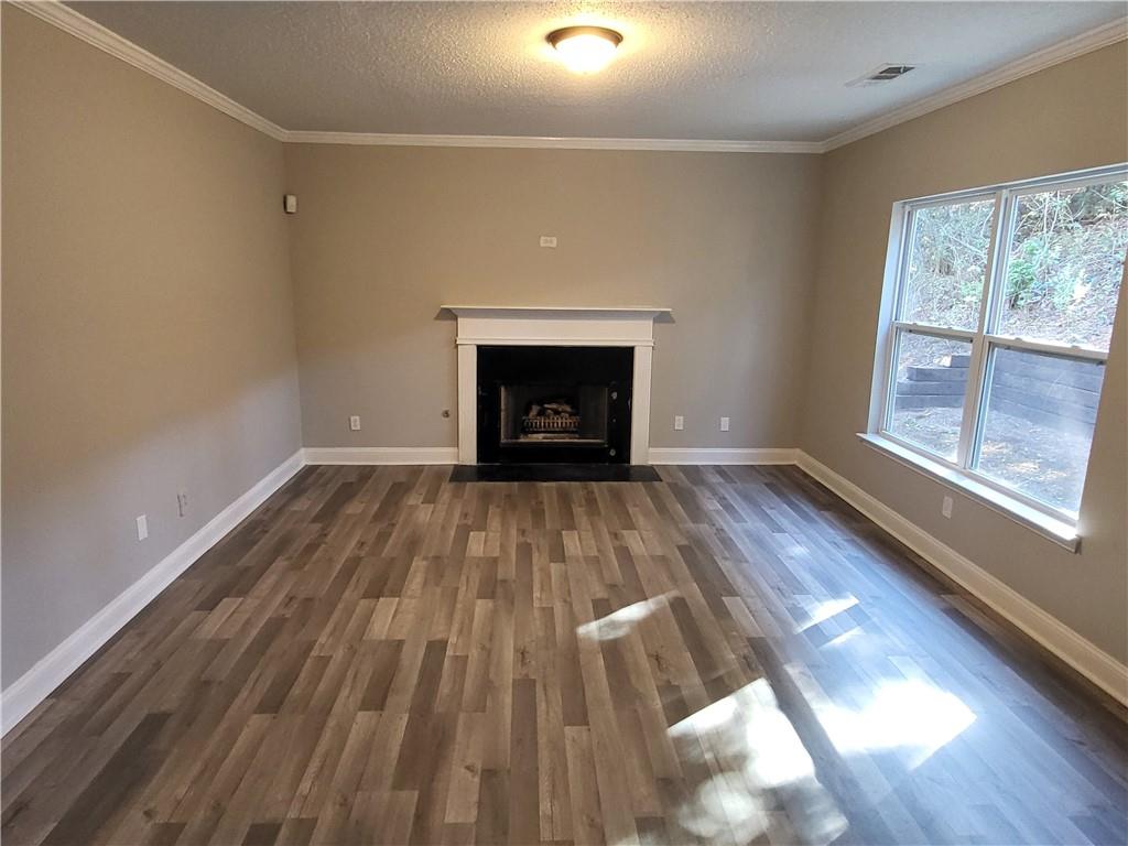 4234 Winston Circle Atlanta, GA 30349 - Photo 7 of 19 a view of empty room with wooden floor and fireplace