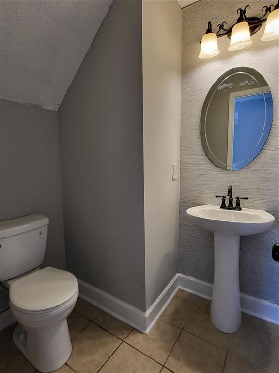 4234 Winston Circle Atlanta, GA 30349 - Photo 8 of 19 a bathroom with a sink toilet and a mirror
