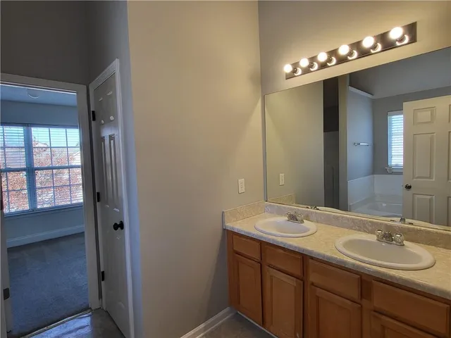a bathroom with a double vanity sink and a mirror