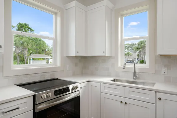 a kitchen with a stove microwave and window