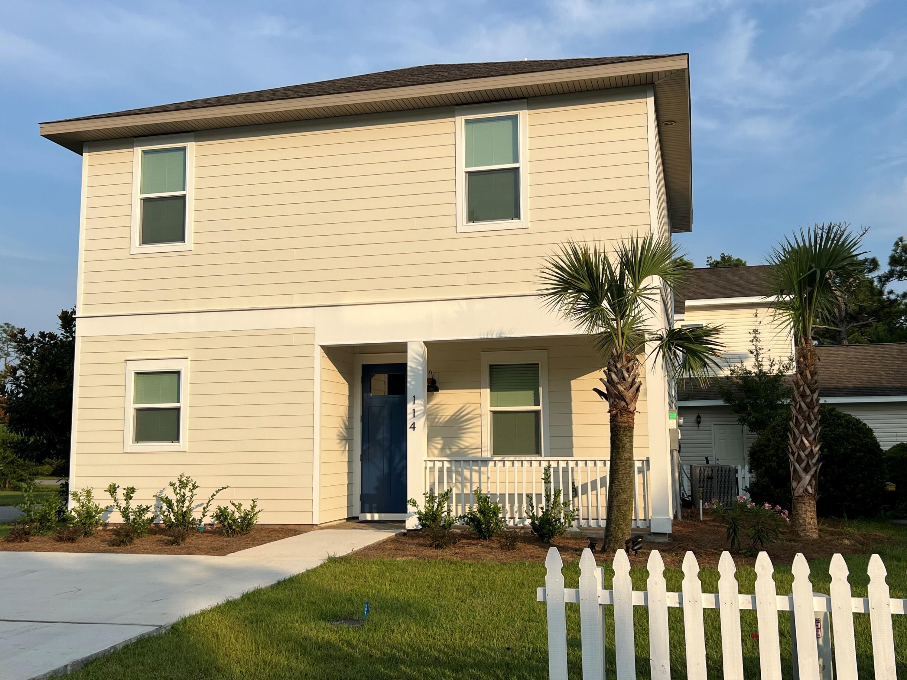 114 Enchanted Way Santa Rosa Beach, FL 32459 - Photo 12 of 33 a front view of a house with a yard