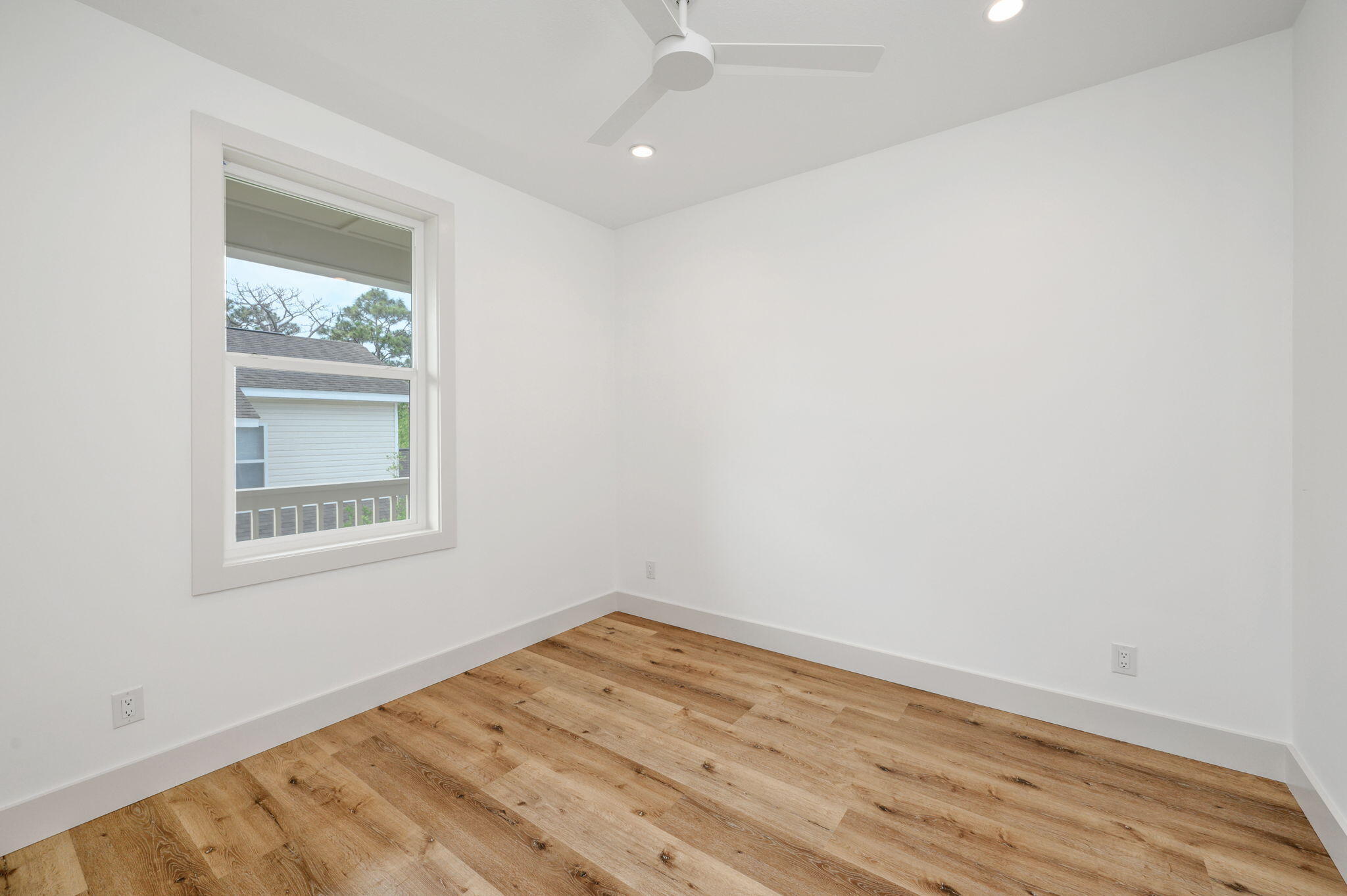 114 Enchanted Way Santa Rosa Beach, FL 32459 - Photo 15 of 33 an empty room with wooden floor and windows